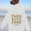 Hooded long sleeved fleece sweatshirt with Faith over fear print
