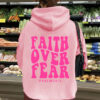Hooded long sleeved fleece sweatshirt with Faith Over Fear print