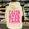 Hooded long sleeved fleece sweatshirt with Faith Over Fear print