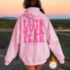 Hooded long sleeved fleece sweatshirt with Faith Over Fear print